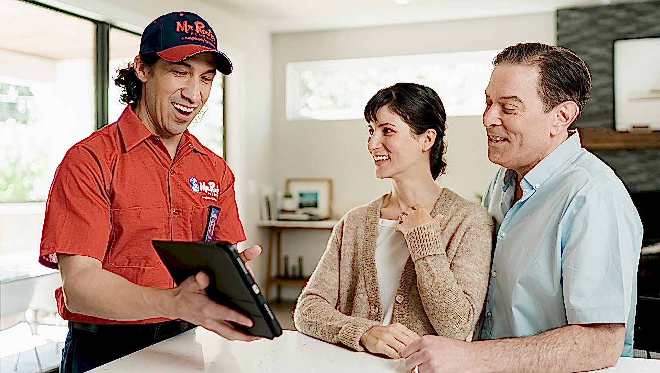 Mr. Rooter technician helping customers choose services.